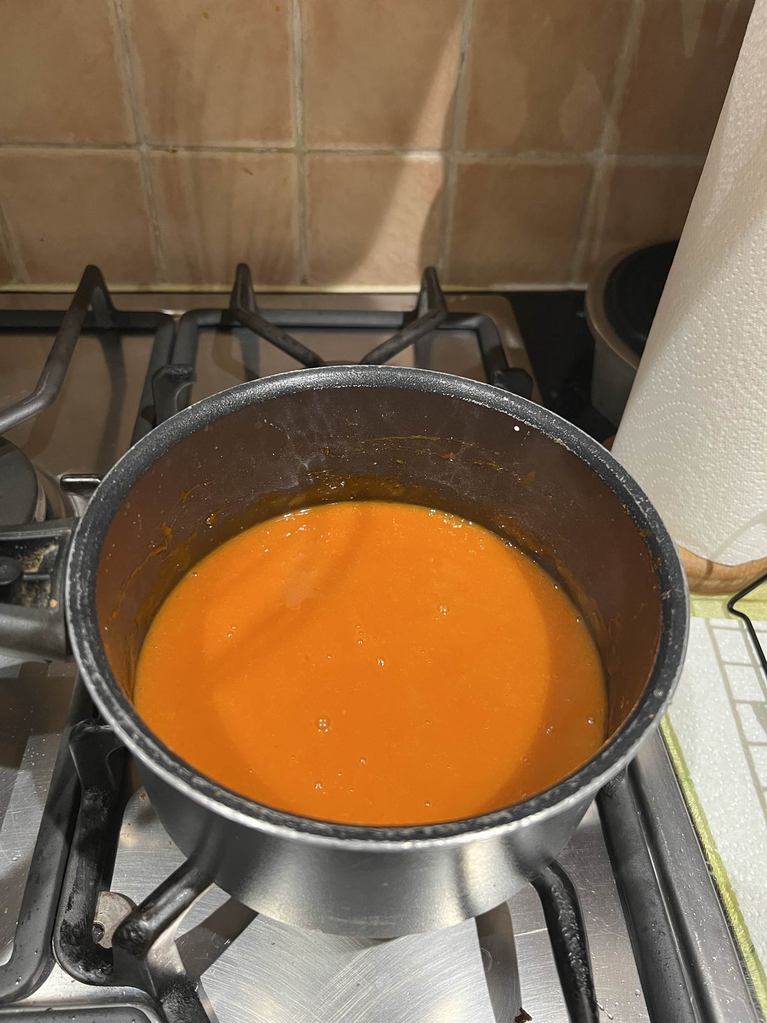 Image of Buffalo Sauce in a saucepan on a gas hob