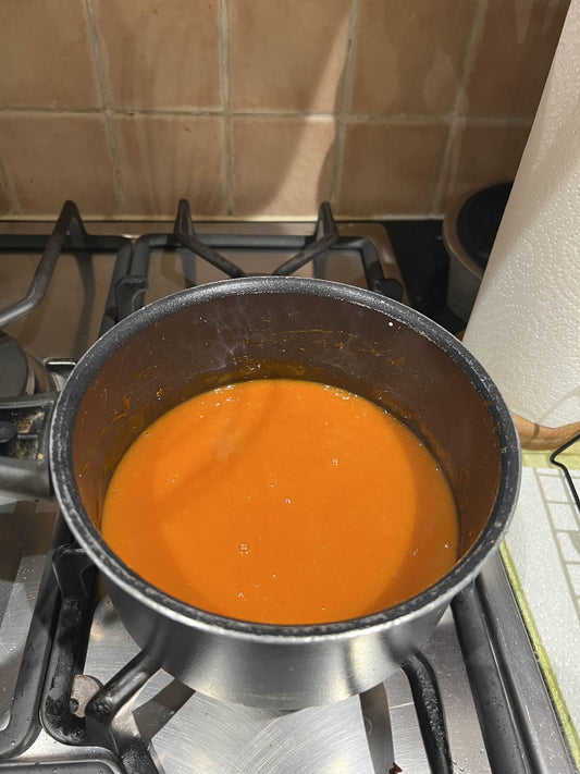 Image of Buffalo Sauce in a saucepan on a gas hob